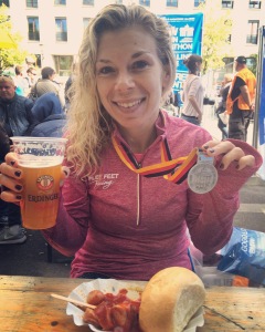 Enjoying a celebratory beer and curry wurst near the finish